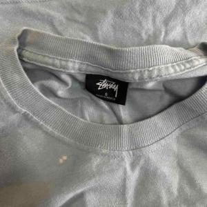 STUSSY シャドーマン Tシャツ カットソー バックプリント 長袖 S 水色 スカイブルー